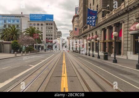 Powell Street by the Union Square is empty of tourists and traffic during the city lockdown due to COVID-19 pandemic, San Francisco, California, USA. Stock Photo