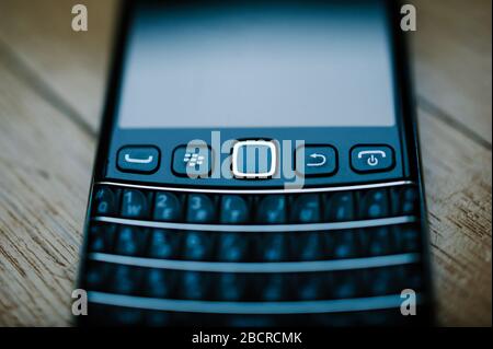 London, United Kingdom - Apr 21, 2013: Tilt-shift lens used on Blackberry Palm vintage smartphones telephone manufactured by Research In Motion Blackberry with full qwerty keyboard Stock Photo