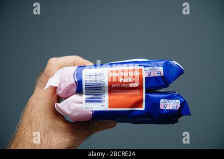 Paris, France - Aug 7, 2019: POV male hands holding fresh toilet wet paper manufactured by Tempo Feuchtes Toilettentucher side view at the duo double special price pack Stock Photo