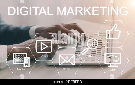 Digital marketing strategies collage with e commerce icons on imaginary screen and businessman working on laptop Stock Photo