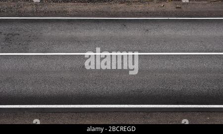 Asphalt highway grey texture with three white stripes Stock Photo