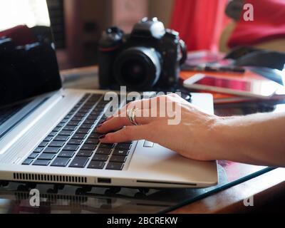 woman Photographer in smart working during quarantine, isolation Stock Photo