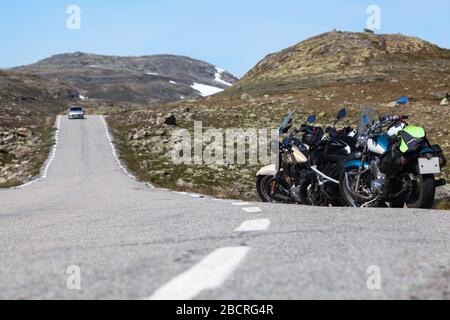 Norwegian Scenic Route Aurlandsfjellet 243 runs across the mountains. Motorcycles parked on a roadside, white line. Norway, Scandinavia Stock Photo