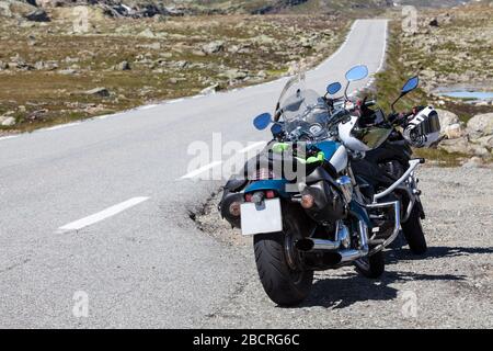 Norwegian Scenic Route Aurlandsfjellet 243 is across the mountains. Motorcycles are parked on roadside, white line. Norway, Scandinavia Stock Photo