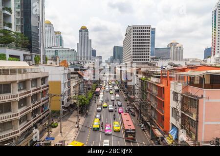 BANGKOK, THAILAND - 16TH MARCH 2017: A view along roads in central Bangkok during the day showing large amounts of traffic and the outside of building Stock Photo