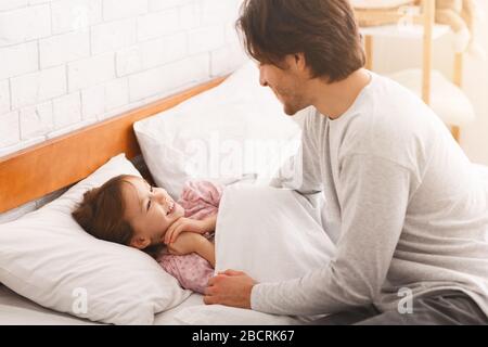 Little girl happy to see her dad in the morning Stock Photo