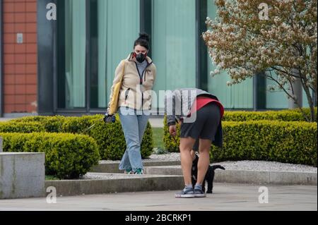 Manchester, UK. 5th Apr 2020. Two dog walkers in face masks in Manchester city centre on Sunday 5th April 2020. (Credit: Pat Scaasi | MI News) Credit: MI News & Sport /Alamy Live News Stock Photo