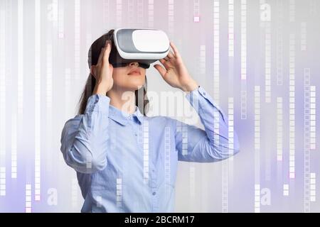 Young woman using VR device on futuristic background with pixels, collage Stock Photo