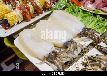 Squid for sale at a fishmonger wet fish market stall, Kata Beach, Phuket, Thailand Stock Photo