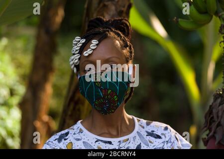 A Kenyan woman wearing a homemade mask made out off traditional Kanga fabric for protection against covid-19 pandemic. Surgical masks are in short sup Stock Photo