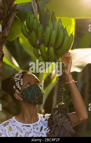 A Kenyan woman wearing a homemade mask made out off traditional Kanga fabric for protection against covid-19 pandemic. Surgical masks are in short sup Stock Photo