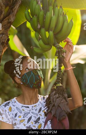 A Kenyan woman wearing a homemade mask made out off traditional Kanga fabric for protection against covid-19 pandemic. Surgical masks are in short sup Stock Photo