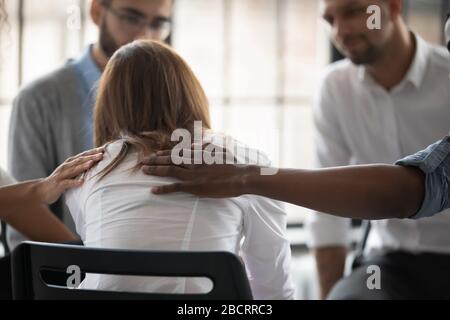 Close up back view unhappy woman with supporting diverse people. Stock Photo