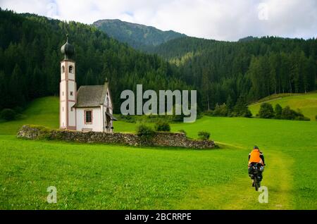 church in the foothills of the Dolomites. Funes Valley, Dolomites, Italy. St John church under autumn sun Stock Photo