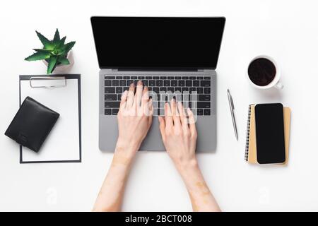 Closeup top view of woman working on laptop Stock Photo