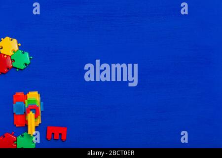Multi-colored children's development games designer toys on a blue background Stock Photo