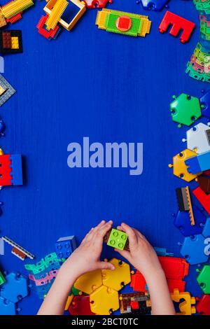 Multi-colored children's development games designer toys on a blue background Stock Photo