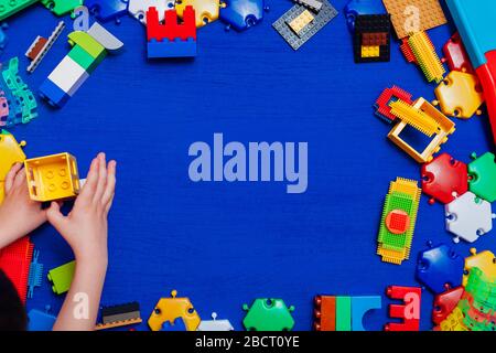 Multi-colored children's development games designer toys on a blue background Stock Photo