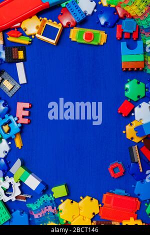 Multi-colored children's development games designer toys on a blue background Stock Photo