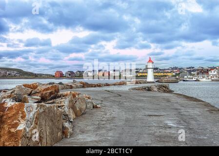 Vardo, Norway - 26 Nowember, 2018: View of the road to lighthouse and opposite side of town coastline with houses and boats Stock Photo