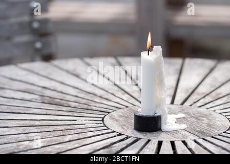 Still life of garden lighting candles on wooden table outdoor Stock Photo