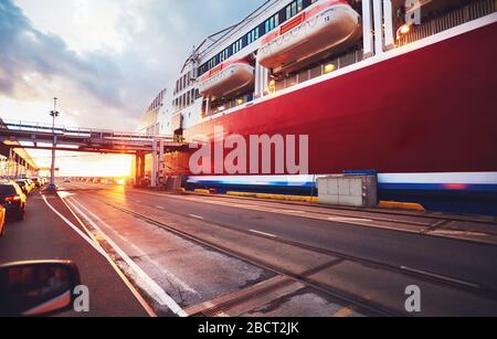 cars are waiting in a queue for loading onboard of big ferry ship, cruise liner in transport port Stock Photo