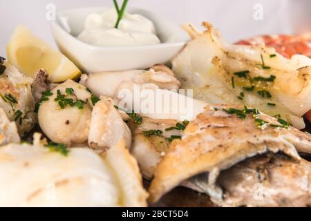 Grilled fish dish with cuttlefish, prawns, hake, sole and squid. Stock Photo