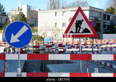 complex civil engineering construction site with road or traffic sign signaling work on the road and mandatory direction. Stock Photo