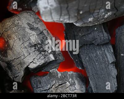 close up of glowing coals in a barbecue grill, charcoal background Stock Photo