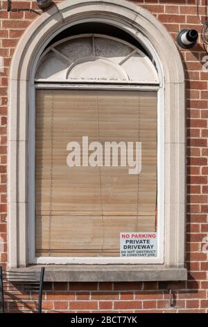 a close up view of a bay window with the shutters closed Stock Photo