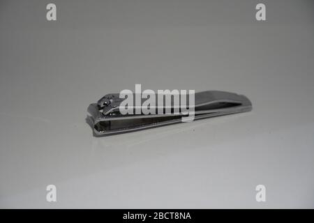 Side View of a steel nail cutter isolated on white background. Old nail clippers viewed from its side. Stock Photo
