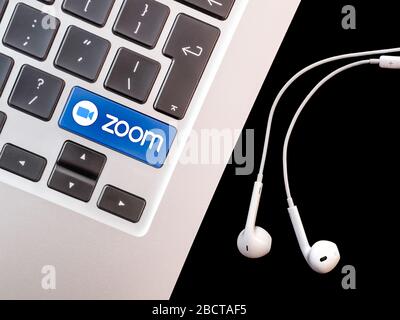 Brussels, Belgium - 4 April 2020: zoom logo on a laptop keyboard. Illustration of the popular app for remote conferencing. Stock Photo