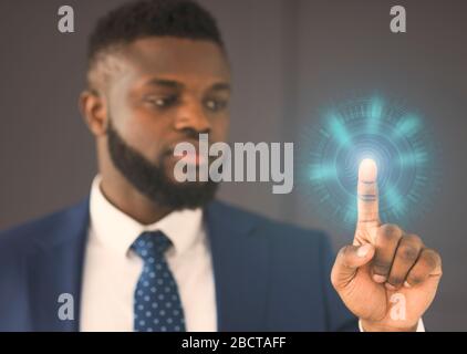 Businessman Touching Virtual Panel Scanning Fingerprint For Access In Office Stock Photo