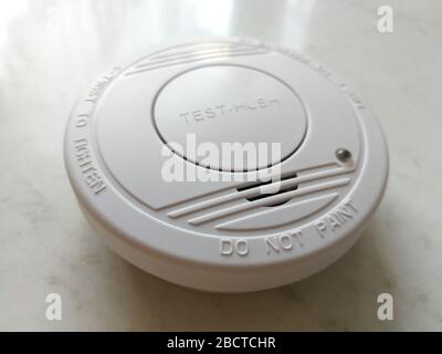 Plastic smoke alarm sensor isolated on the white background Stock Photo