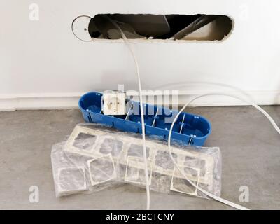Electric equipment prepare to be installed in the plasterboard wall Stock Photo
