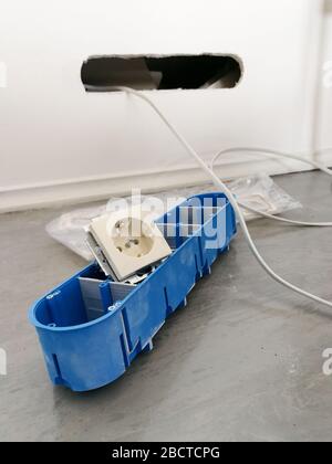 Electric equipment prepare to be installed in the plasterboard wall Stock Photo