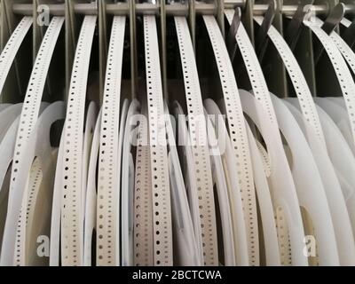 Paper reels with various electronic components resistors, capacitors, inductors close up Stock Photo