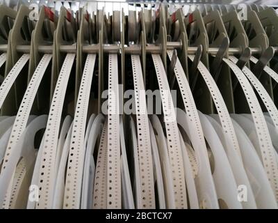 Paper reels with various electronic components resistors, capacitors, inductors close up Stock Photo