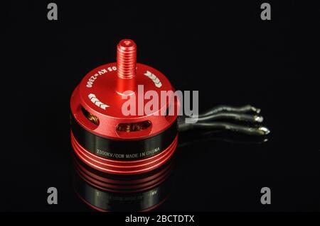 Small brushless motor for racing drones on the dark background Stock Photo