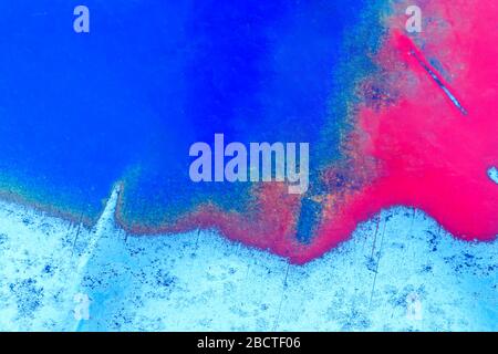 Abstract color background. The metal plate is painted red and blue. time-polished metal Stock Photo