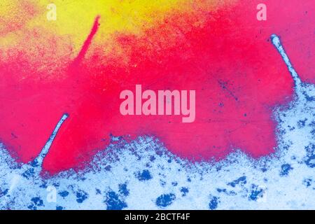 abstract background. red-yellow paint applied to a metal old plate Stock Photo