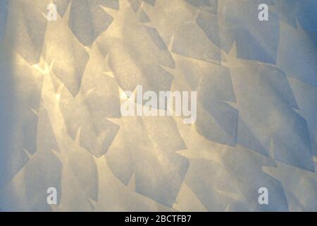 Airy soft fluffy artificial bird wing with a white feather close-up macro of pastel blue shades. Abstract gentle soft background with breaking light. Stock Photo