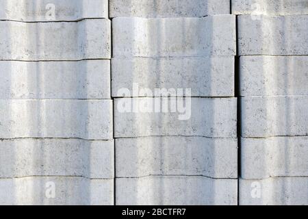 gray road tile is folded into a block on a pallet for the reconstruction of the road, square, sidewalk. paving background Stock Photo