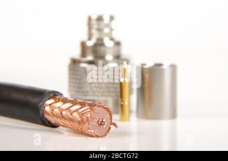 Half prepared for crimping coaxial cable and N type connector in the background Stock Photo