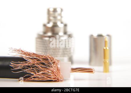 Half prepared for crimping coaxial cable and N type connector in the background Stock Photo