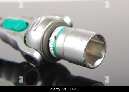 Professional mechanical tool socket wrench close up on the reflective dark background Stock Photo