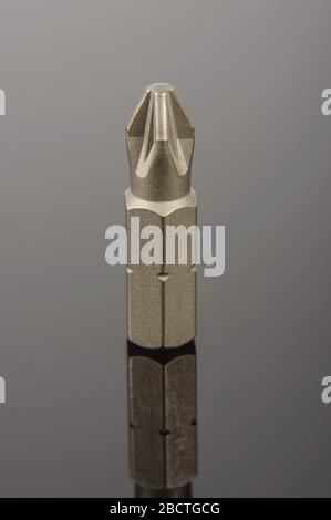 Professional mechanical screwdriver bit close up on the dark reflective background Stock Photo