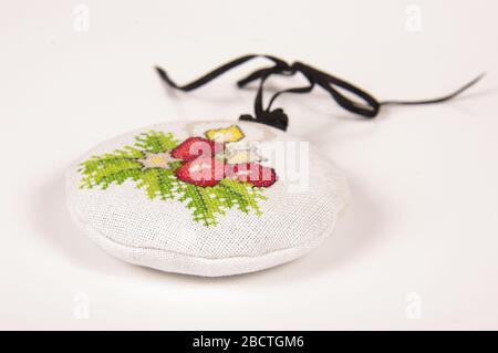 Christmas ornaments cross-stitched bag filled with levander blooms on white background Stock Photo