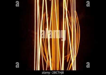 Old style lamp filament glowing in the dark Stock Photo