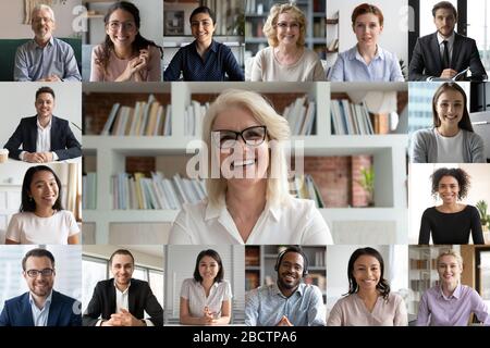 Webcam view people engaged in videoconference lead by mature businesswoman Stock Photo